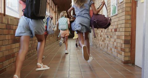 Joyful Schoolgirls Running in School Corridor - Download Free Stock Images Pikwizard.com