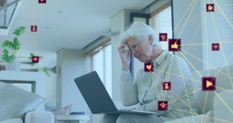 worried senior woman using laptop with digital interface icons - Download Free Stock Images Pikwizard.com