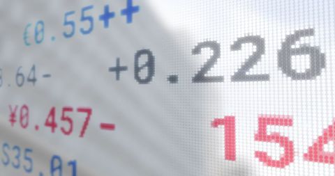 Digital stock market data overlaid on cityscape