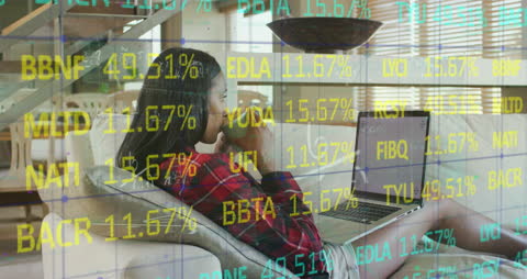 Woman Analyzing Financial Data on Laptop at Home