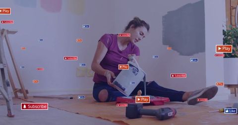Woman in home improvement project pouring paint