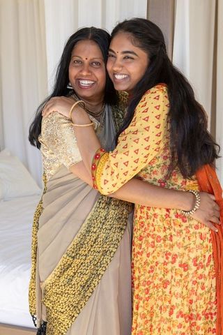 Indian mother and daughter hugging in traditional attire