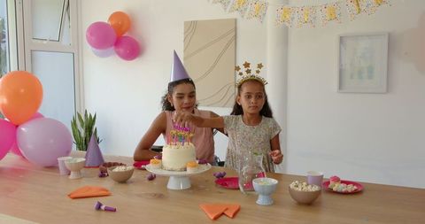 Mother and Daughter Celebrating Birthday with Cake at Home
