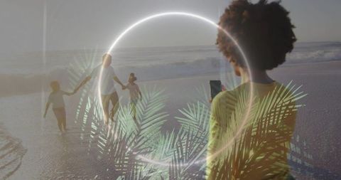 Filming family walking on wet sand with neon ring and palm double exposure at golden hour