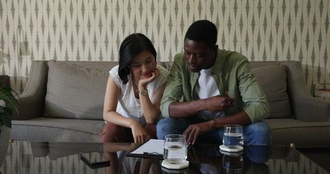 Couple planning wedding at home discussing details