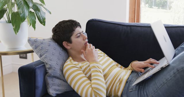 Young Woman Relaxing on Couch with Laptop in Comfortable Living Room - Download Free Stock Images Pikwizard.com