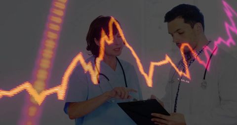 Medical team analyzing data with ecg overlay in clinic setting