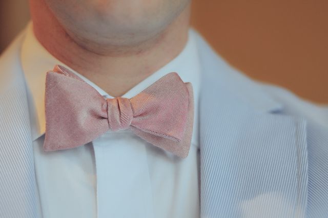Close-Up of Man Wearing Pink Bow Tie and Light Blue Jacket - Download Free Stock Photos Pikwizard.com