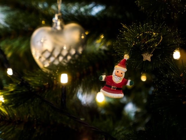 Close-up of Christmas Tree Decorations with Santa Ornament and Lights - Download Free Stock Photos Pikwizard.com