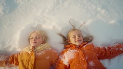 Siblings Creating Snow Angels Together in Winter Wonderland