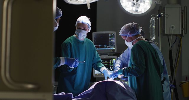 Image of diverse male assistant and female surgeons operating on patient in operating theatre - Download Free Stock Photos Pikwizard.com
