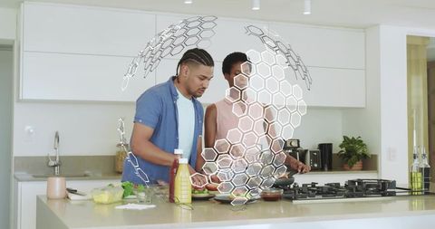 Young couple preparing healthy meal at modern kitchen island with ar hexagon interface