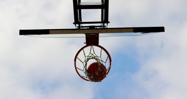 Basketball Hoop with Ball in Basket Against Sky - Download Free Stock Images Pikwizard.com