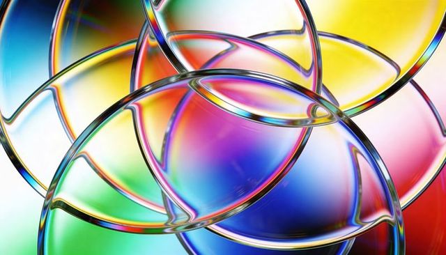 Overlapping glass lenses bending iridescent light, reflecting prismatic rings backlit