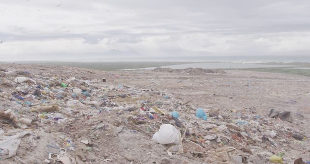 This is an illustrative representation of a large landfill filled with different kinds of waste, prominently plastic waste. This photo serves as a dramatic visual aid for topics regarding environmental pollution, waste management, sustainability, and the climate crisis. It can be effectively used in articles, presentations, and educational materials highlighting the impact of human activities on the planet and the urgency for sustainable practices.