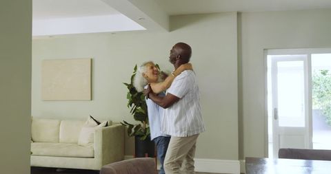 Senior Couple Enjoying Dance in Bright Living Room