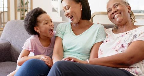 Multigenerational African American Family Laughing on a Cozy Couch
