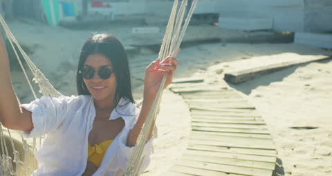 Relaxing on Hammock by Ocean Beach in Summer