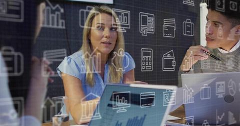 Team Meeting Discussing Data Insights and Financial Charts on Laptops