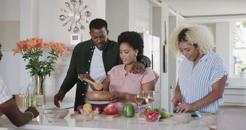 Happy Friends Enjoying Cooking in Modern Kitchen