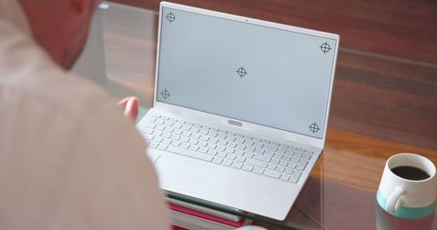 Man Working on Laptop in Minimalistic Home Office