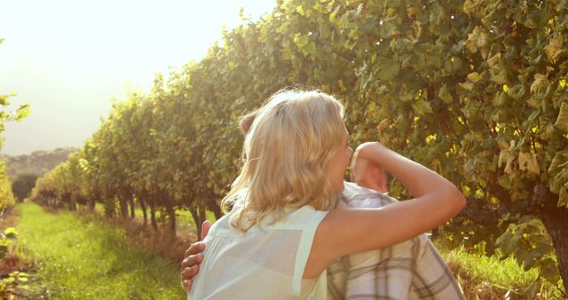 A Caucasian couple enjoys a romantic moment in a lush vineyard, with copy space. Their embrace captures the essence of a serene and intimate getaway amidst nature.