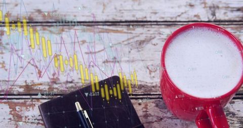 Red mug foaming on rustic wooden table with notebook, pen and finance analytics chart overlays