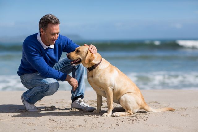 Smiling mature man with his dog on the beach
