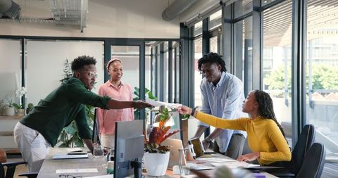 Diverse team collaborating on new business project in modern office