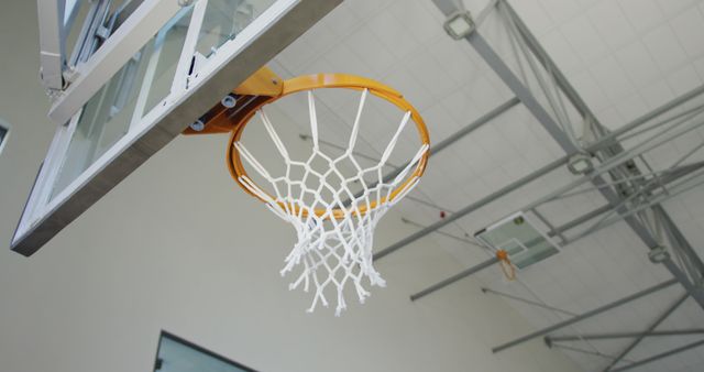 Caucasian male basketball player scoring goal during match. basketball, sports training at an indoor court.