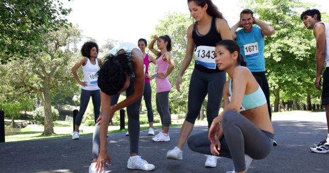 Group of Young Athletes Stretching After Running Event in Park - Download Free Stock Images Pikwizard.com