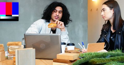 Colleagues Having Breakfast During Meeting in Modern Office