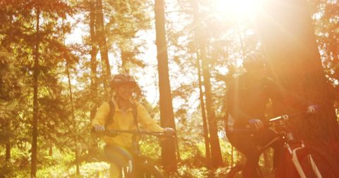 Active Couple Enjoying Mountain Biking in Forest Sunshine - Download Free Stock Images Pikwizard.com