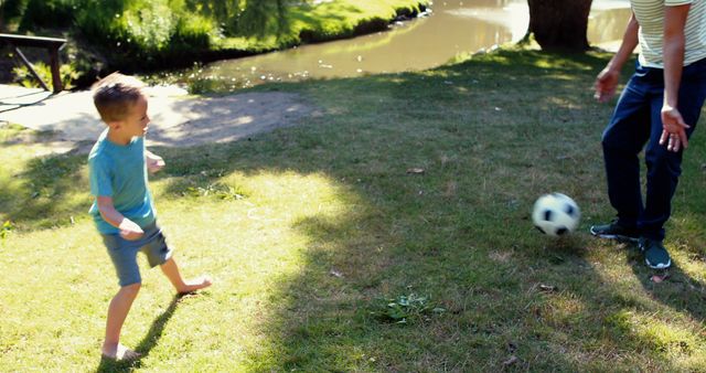 Father and Son Playing Soccer Outdoors in Sunny Park - Download Free Stock Images Pikwizard.com