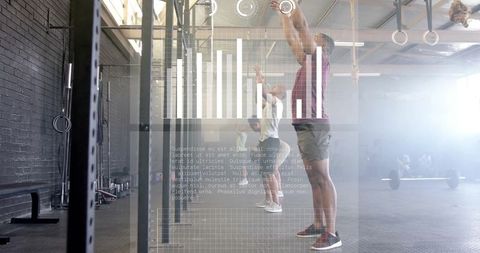 Athletes training in crossfit gym with data overlay on performance