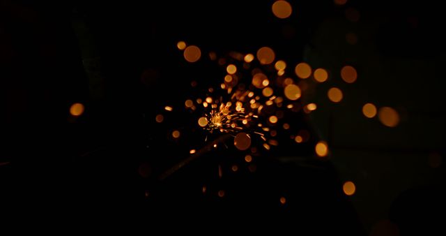Sparks fly in a dark environment, creating a dramatic and mesmerizing effect - Download Free Stock Photos Pikwizard.com