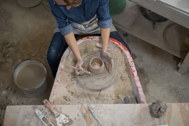 Overhead of female potter molding a clay - Download Free Stock Photos Pikwizard.com