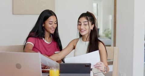 Friends Collaborating at Home with Technology and Refreshments