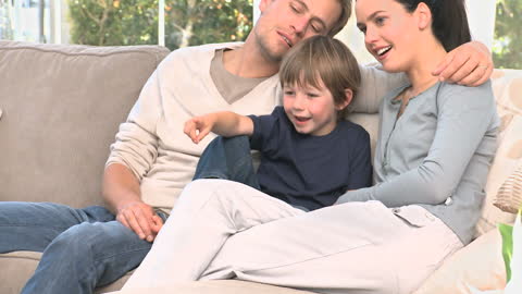 Family Enjoying Fun Television Time Together at Home