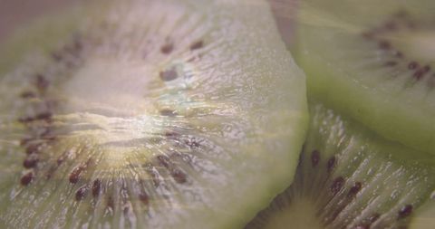 Macro View of Fresh Kiwi Fruit Slices Spotlighting Vibrant Seed Patterns