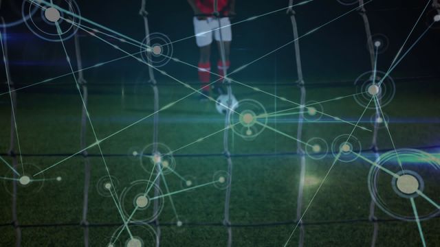 Video features a male soccer player about to take a penalty kick, overlayed with futuristic network connections, highlighting the integration of technology and sports. Ideal for illustrating advancements in sports science, smart analytics, or the impact of technology in athletic performance enhancement.