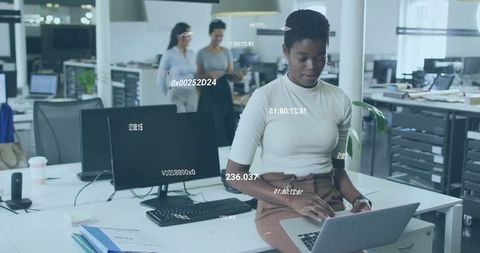 Young Professional Working with Laptop in Modern Open-Plan Office