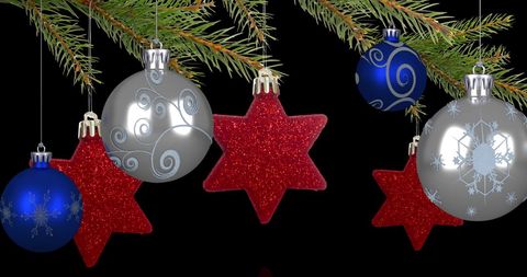 Christmas Decorations Hanging from Fir Tree on Black Background