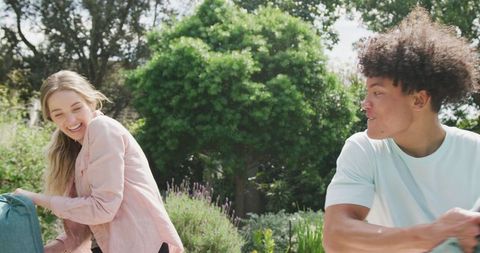 Joyful Couple Having Fun in Lush Garden on Sunny Day