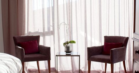 Cozy Seating Area with Brown Armchairs by Sunlit Window - Download Free Stock Images Pikwizard.com