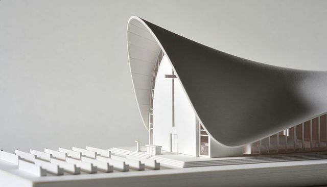 Minimalist scale church model with sweeping curved roof, recessed cross, foamcore