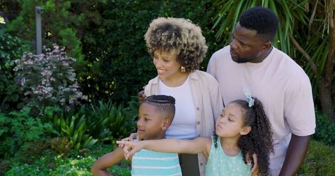 Diverse Family Enjoying Lush Backyard Garden