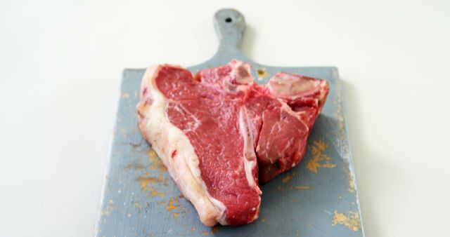 Raw T-bone Steak on Cutting Board - Download Free Stock Images Pikwizard.com