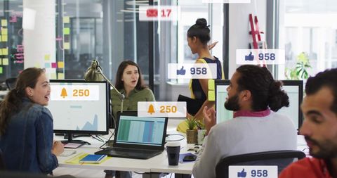 Digital team collaborating in modern office with social media icons