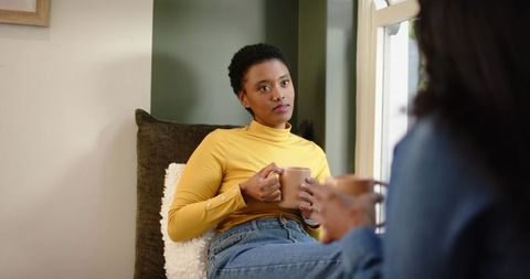 Diverse female friends engaging in cozy home conversation
